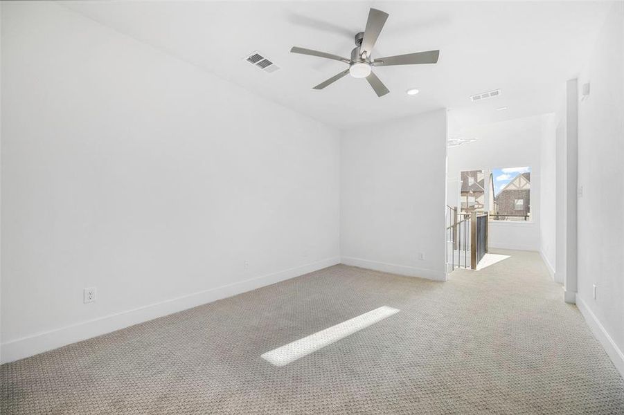 Empty room featuring recessed lighting, visible vents, light carpet, and baseboards