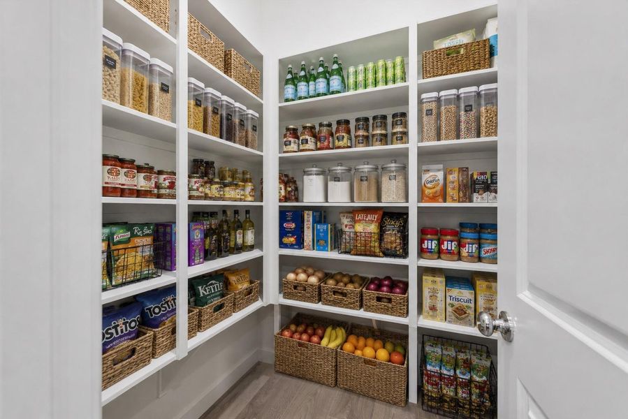 walk in pantry. *this photo is a digitally staged representation of a previously built home*