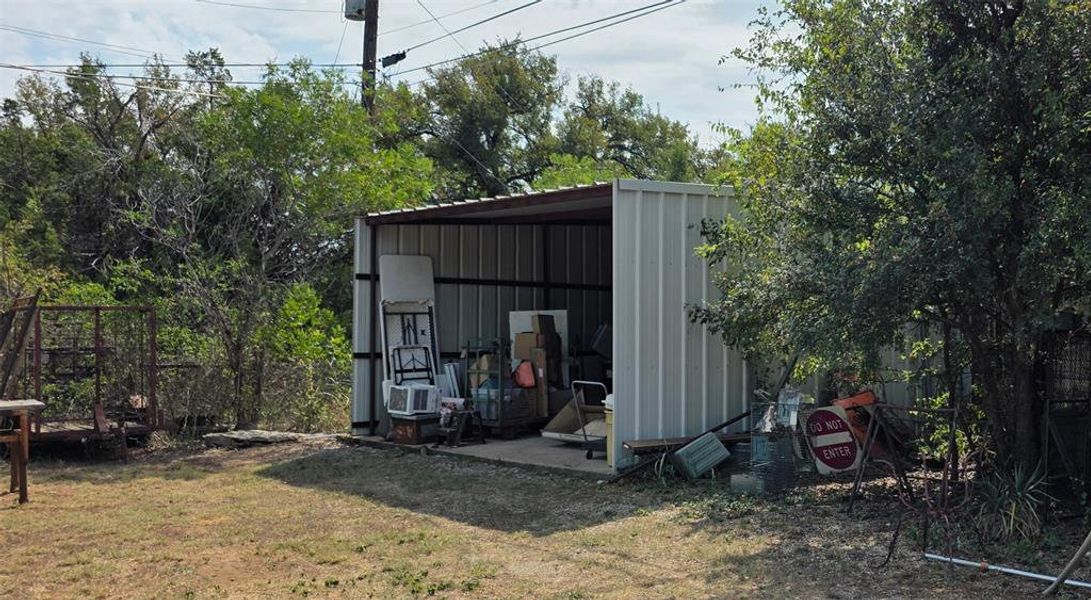 View of pole building featuring a lawn View of pole building featuring a lawn