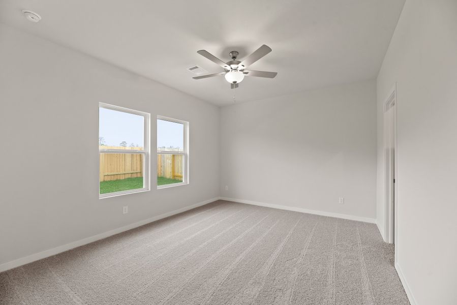 A room with a ceiling fan and a window. A room with a ceiling fan and a window.