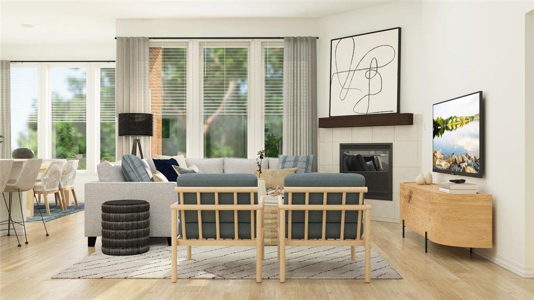 Living room featuring light wood-type flooring and a tile fireplace