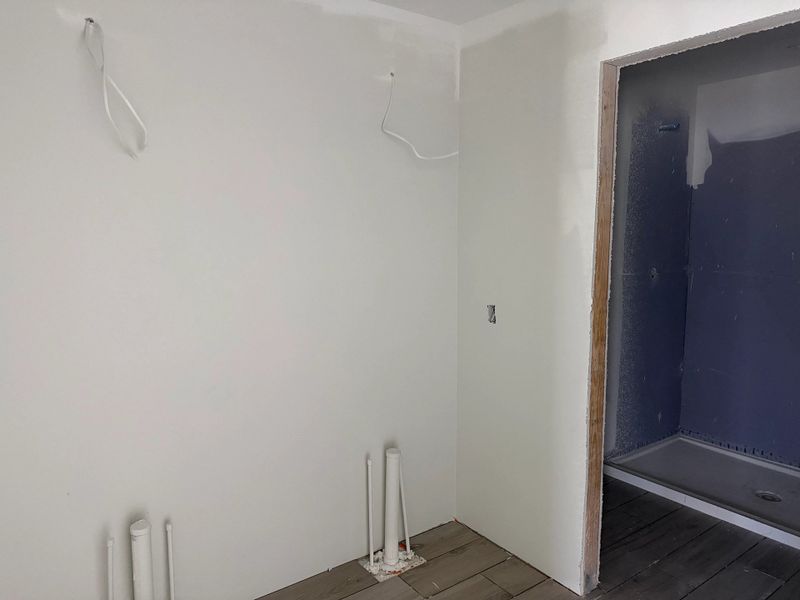 Primary bathroom will feature double sinks and a frameless walk-in shower - under construction Primary bathroom will feature double sinks and a frameless walk-in shower - under construction