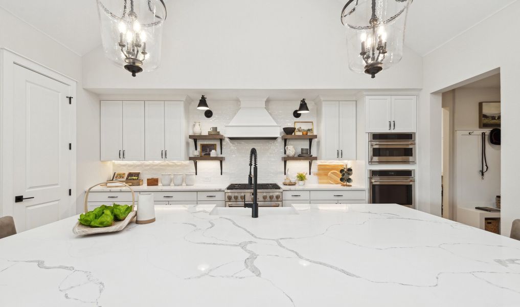 Kitchen with floating shelves and quartz countertops