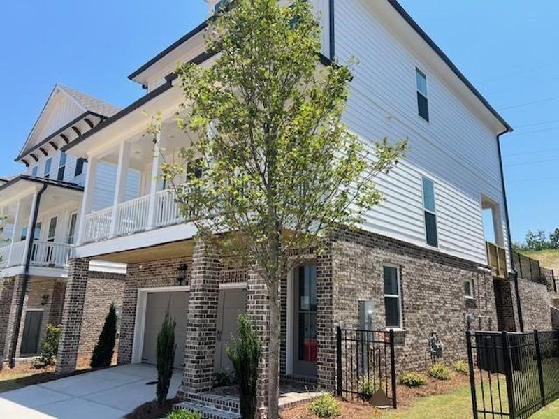 Front exterior of a new home in Palisades Single Family, Cumming, GA, highlighting curb appeal (Image 22).