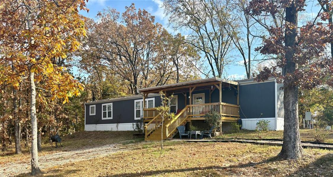 View of front of house with a deck and stairway