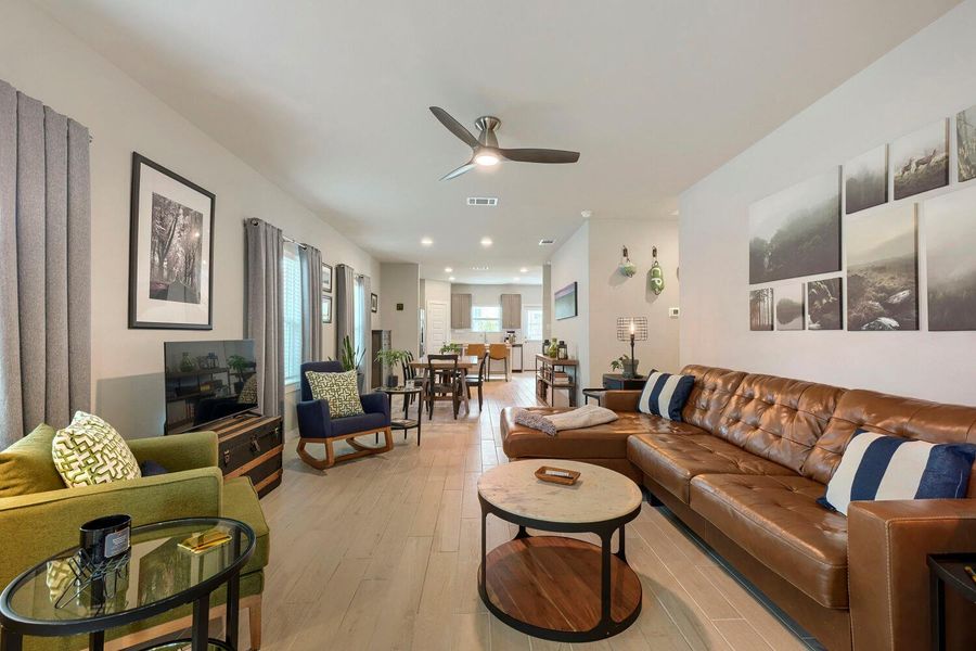 An inviting open-concept living area flows seamlessly into the dining space and kitchen, perfect for entertaining. An inviting open-concept living area flows seamlessly into the dining space and kitchen, perfect for entertaining.