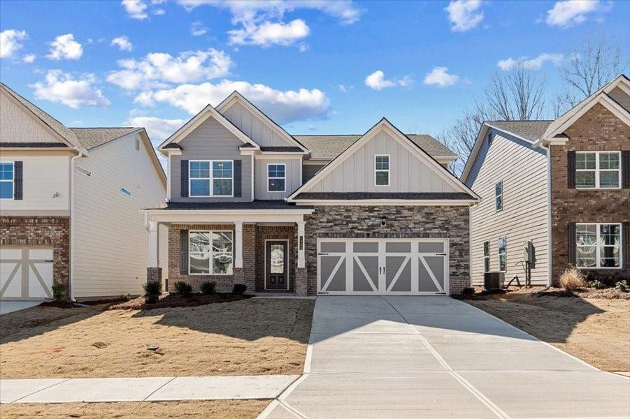 Front exterior of a new home in Clark Farms, Flowery Branch, GA, highlighting curb appeal (Image 1). Front exterior of a new home in Clark Farms, Flowery Branch, GA, highlighting curb appeal (Image 1).