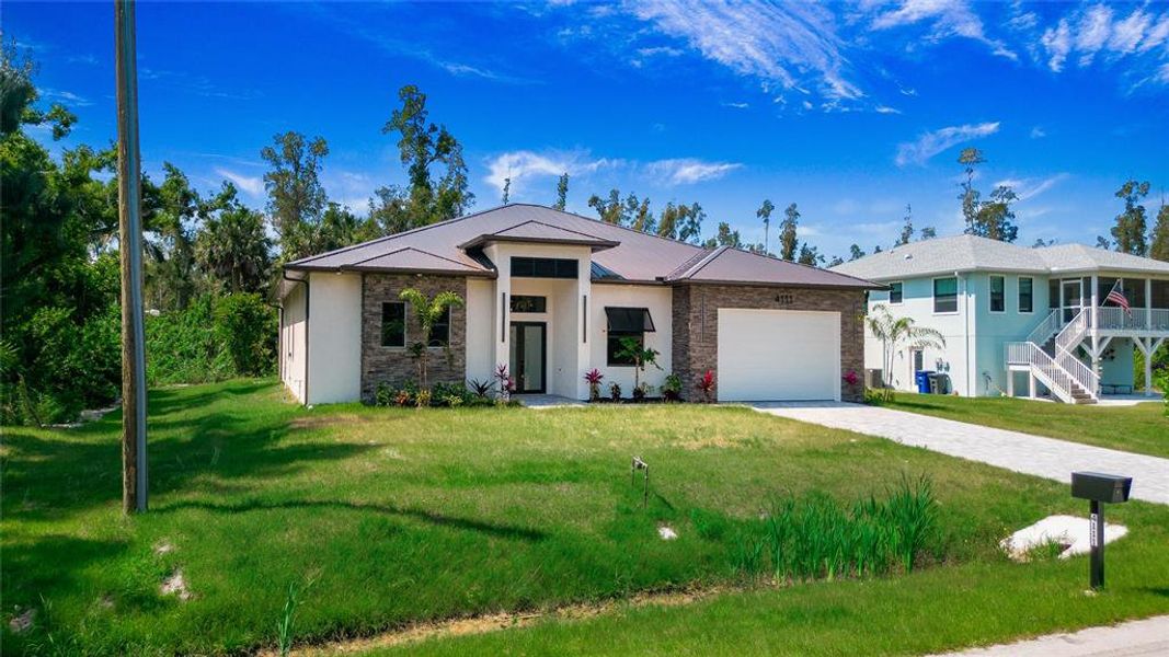 Front exterior of a new home in , Estero, FL, highlighting curb appeal (Image 2). Front exterior of a new home in , Estero, FL, highlighting curb appeal (Image 2).