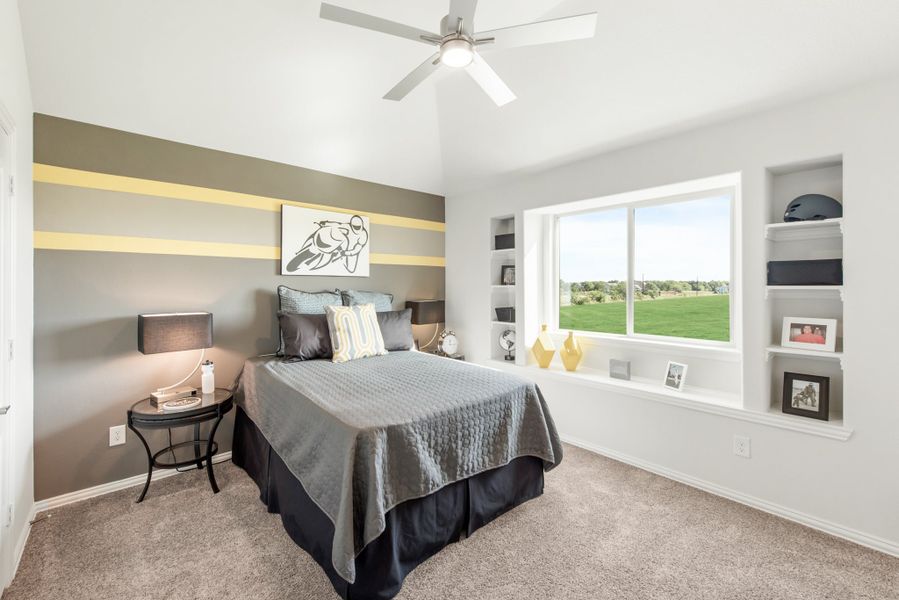Bedroom with striped accent wall, built-in shelves, ceiling fan, and large window with outdoor view