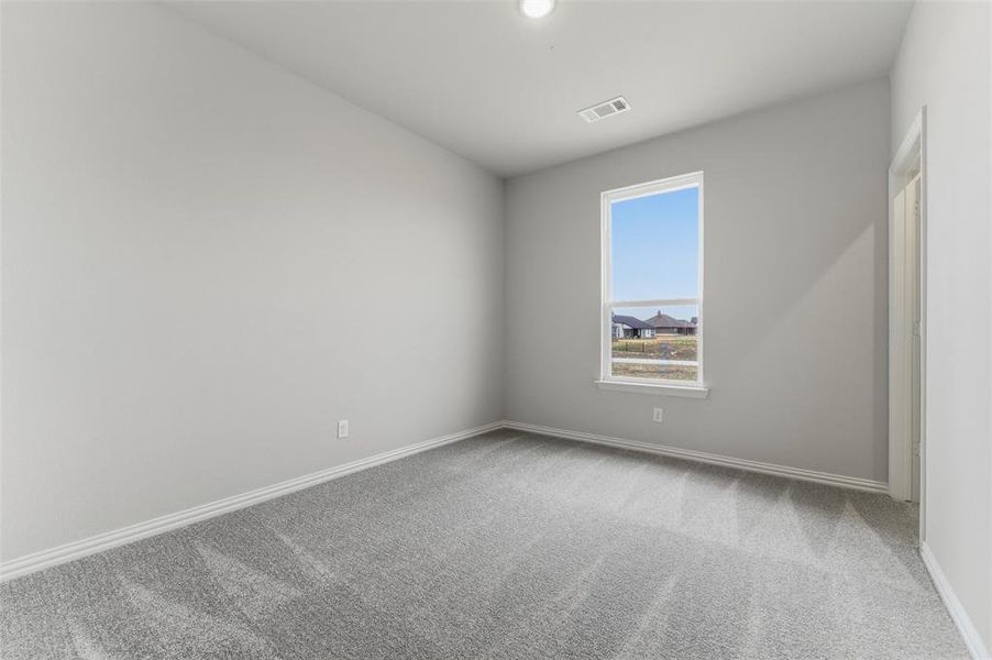 Empty room with light carpet and baseboards
