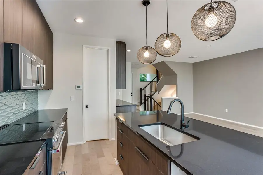 Photos are of unit #204. Unit #101 will feature white cabinets and grey wood floors. Photos are of unit #204. Unit #101 will feature white cabinets and grey wood floors.
