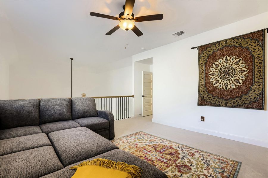 Relaxation awaits in this airy living space, complete with a classic ceiling fan for comfort. Relaxation awaits in this airy living space, complete with a classic ceiling fan for comfort.