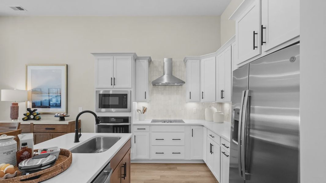 Open kitchen in the Summit home plan with modern cabinetry and natural light.