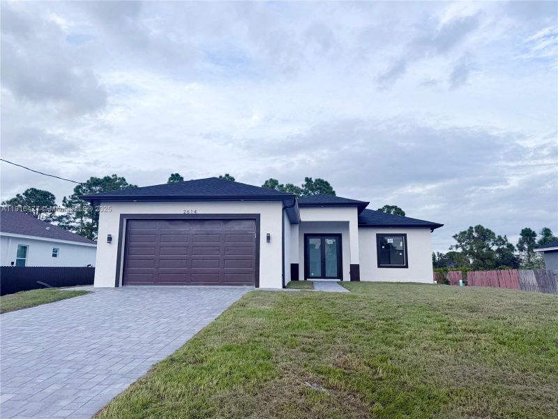 Front exterior of a new home in , Lehigh Acres, FL, highlighting curb appeal (Image 19). Front exterior of a new home in , Lehigh Acres, FL, highlighting curb appeal (Image 19).