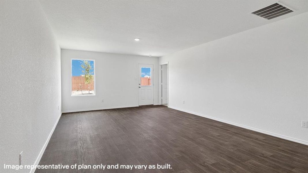 Spare room featuring dark wood-style flooring and a textured wall
