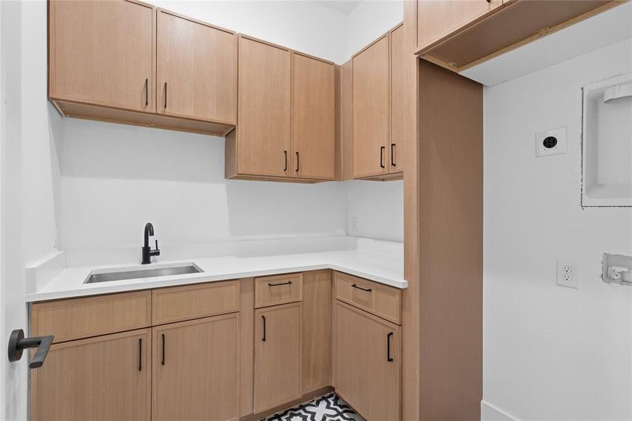 Kitchen featuring light wood finish cabinets and light countertops