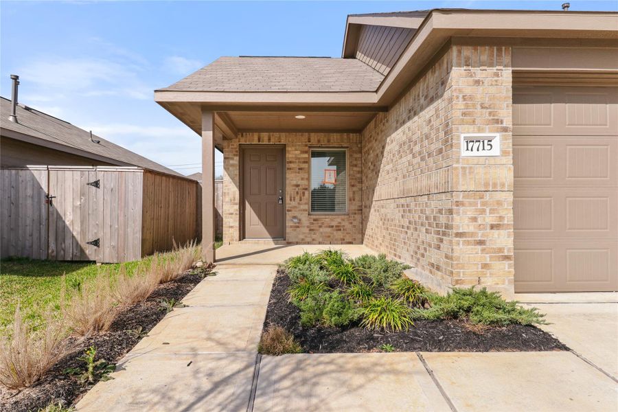 Welcoming covered porch with landscaped approach—great for greeting guests Welcoming covered porch with landscaped approach—great for greeting guests
