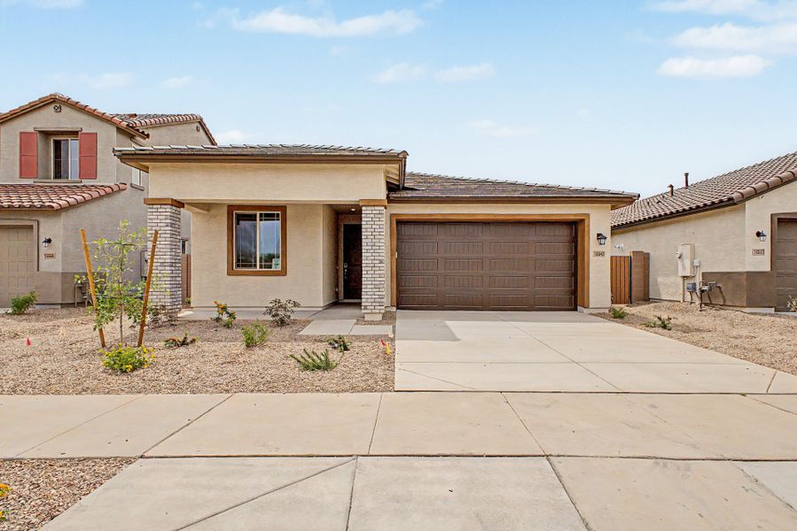 Front exterior of a new home in Mason Ranch II, Surprise, AZ, highlighting curb appeal (Image 1). Front exterior of a new home in Mason Ranch II, Surprise, AZ, highlighting curb appeal (Image 1).