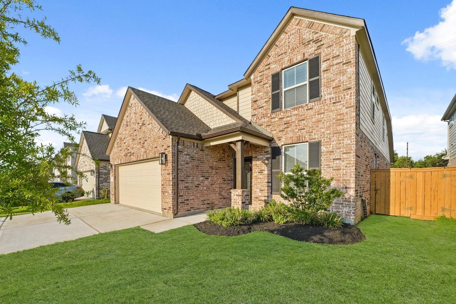 Front exterior of a new home in Sunterra North, Katy, TX, highlighting curb appeal (Image 18). Front exterior of a new home in Sunterra North, Katy, TX, highlighting curb appeal (Image 18).