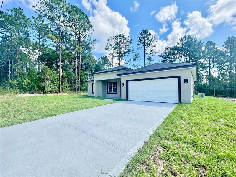 Front exterior of a new home in , Citrus Springs, FL, highlighting curb appeal (Image 18).