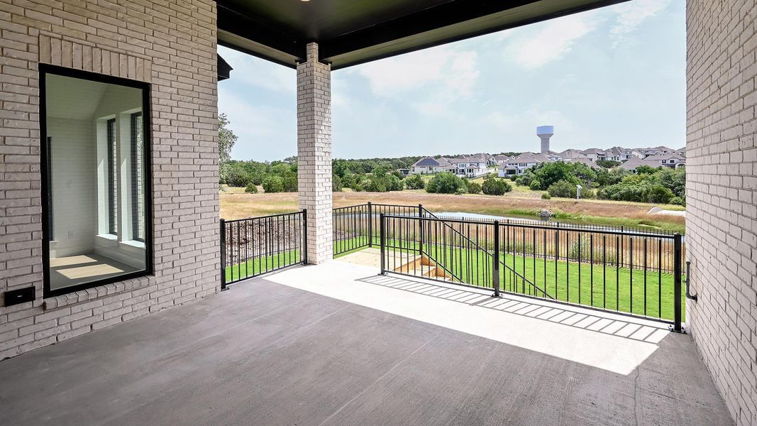 Back of house featuring brick siding