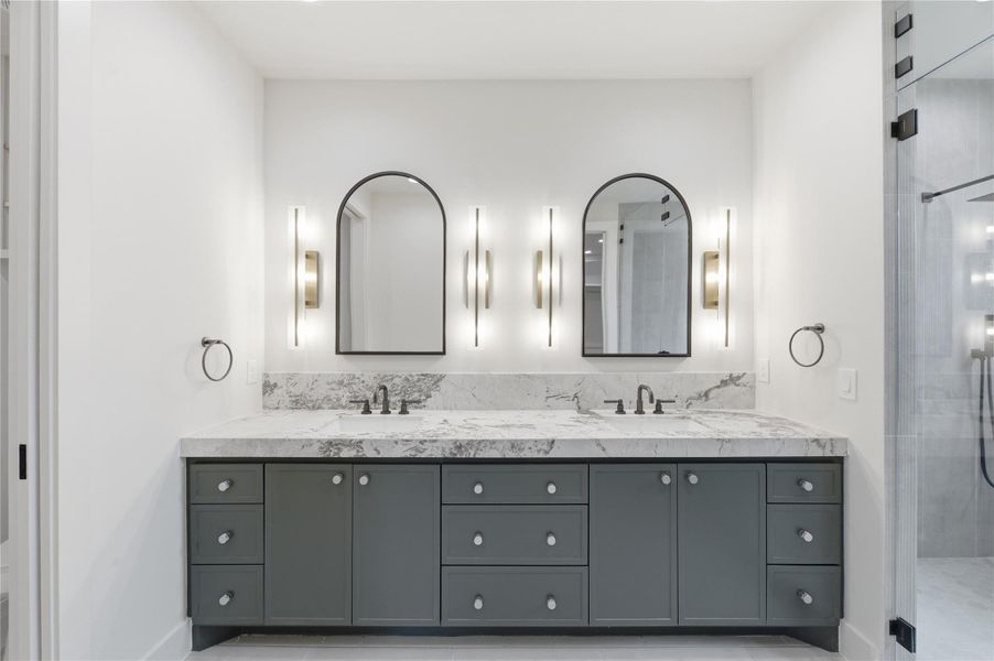 Indulge in spa-like luxury in the stunning primary bath featuring designer finishes, elegant details, and a serene atmosphere.