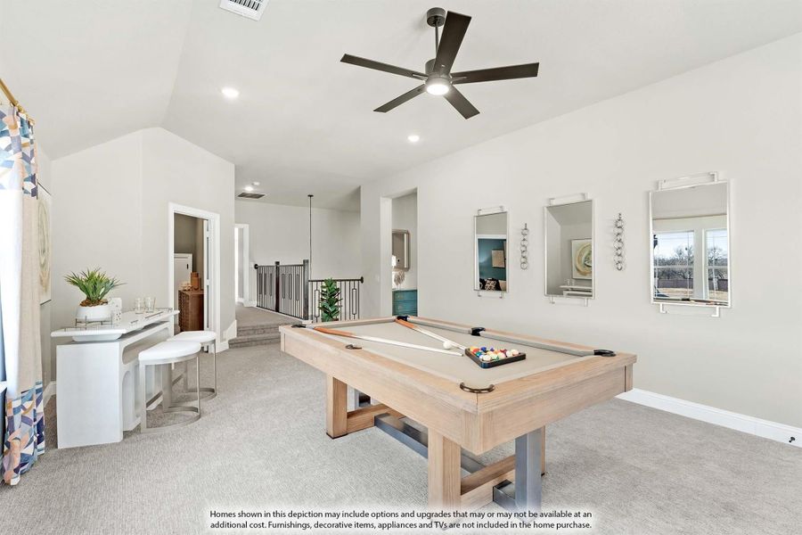 Upstairs game room with pool table, vaulted ceiling, ceiling fan, and carpet flooring Upstairs game room with pool table, vaulted ceiling, ceiling fan, and carpet flooring
