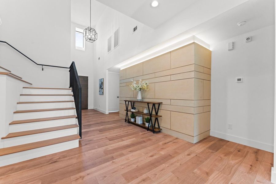 A bold architectural statement: layered birch wood, custom backlighting, and sleek paneling make this entry unforgettable. A bold architectural statement: layered birch wood, custom backlighting, and sleek paneling make this entry unforgettable.