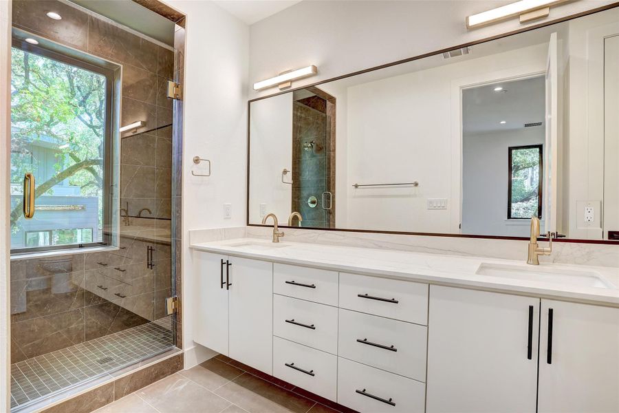 Full bathroom with double vanity, a stall shower, tile patterned flooring, and recessed lighting