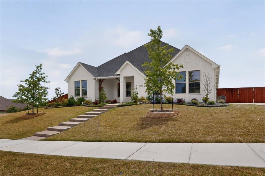 White brick facade with dark shingle roofing White brick facade with dark shingle roofing