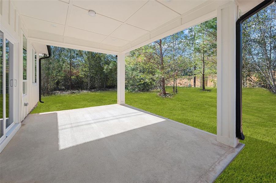 Large covered patio w/patio doors leading into the den.