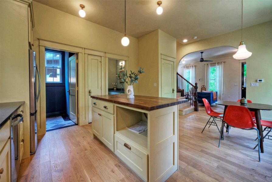 A sleek kitchen island provides a central hub, perfectly complementing the open-concept design and wood flooring.