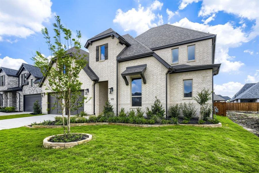 Traditional-style home featuring light brick masonry, dark trim, and a dark shingle roof Traditional-style home featuring light brick masonry, dark trim, and a dark shingle roof