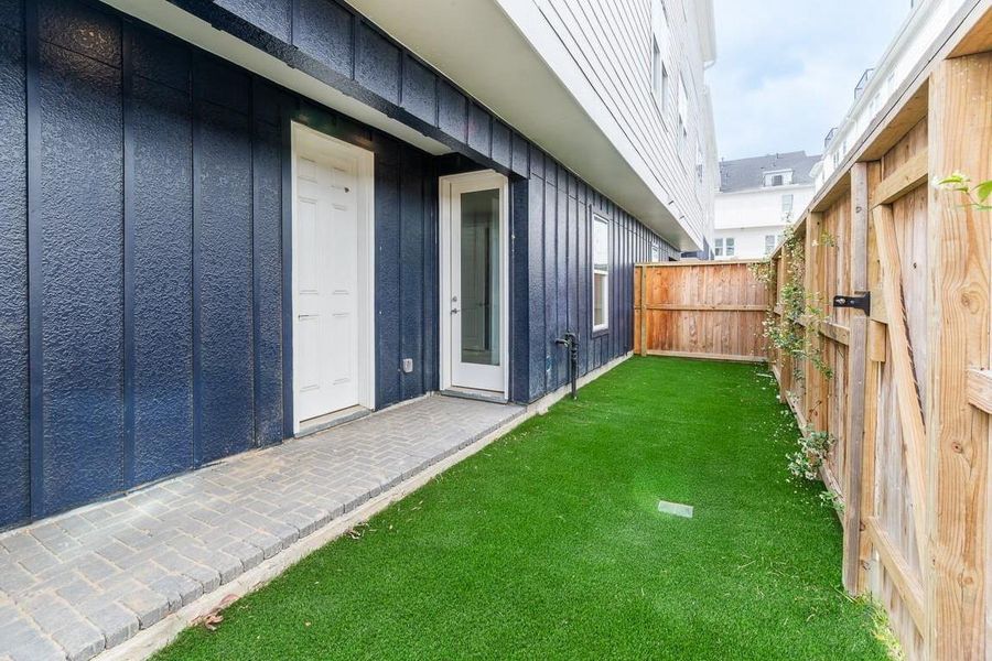 Nice yard space in back that opens to the courtyard area beyond your private yard. Access to garage and 1st floor bedroom.