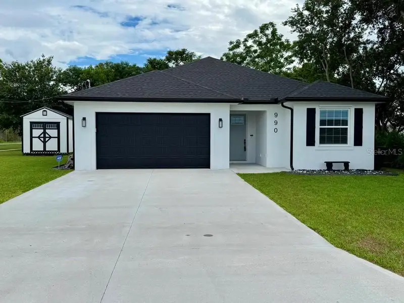 Front exterior of a new home in , Eagle Lake, FL, highlighting curb appeal (Image 1). Front exterior of a new home in , Eagle Lake, FL, highlighting curb appeal (Image 1).