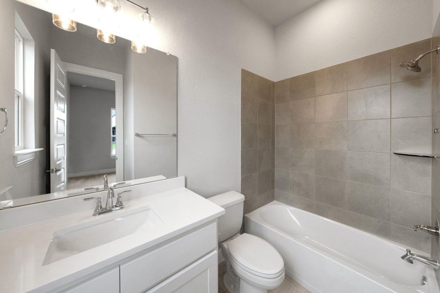 Full bathroom featuring vanity and shower / tub combination Full bathroom featuring vanity and shower / tub combination