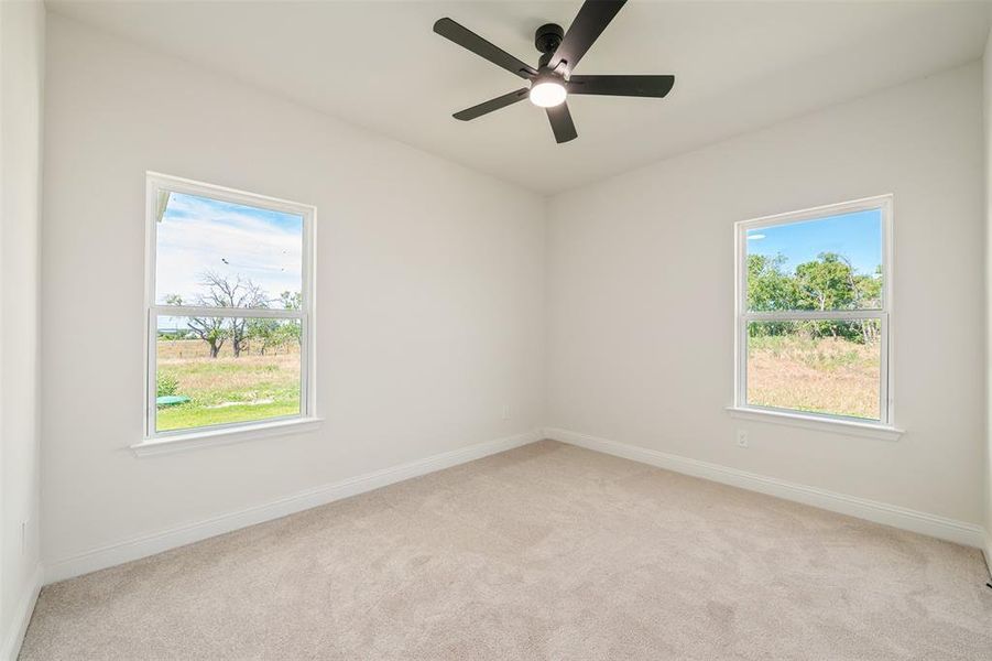 Unfurnished room with light carpet and ceiling fan