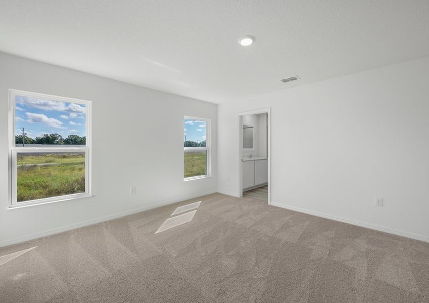 Master bedroom with two windows facing the backyard