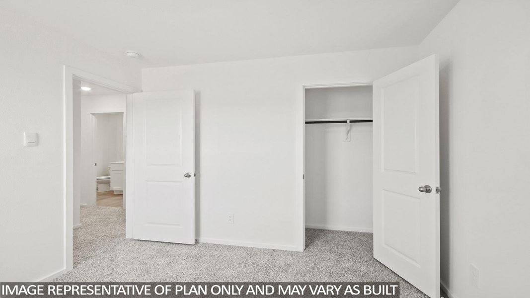 Unfurnished bedroom with light colored carpet and a closet Unfurnished bedroom with light colored carpet and a closet