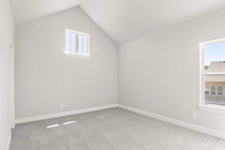 Additional living space with carpet flooring and vaulted ceiling Additional living space with carpet flooring and vaulted ceiling