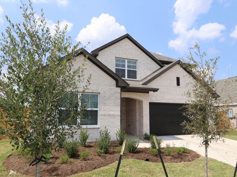 Front exterior of a new home in Miller's Pond, Rosenberg, TX, highlighting curb appeal (Image 15).