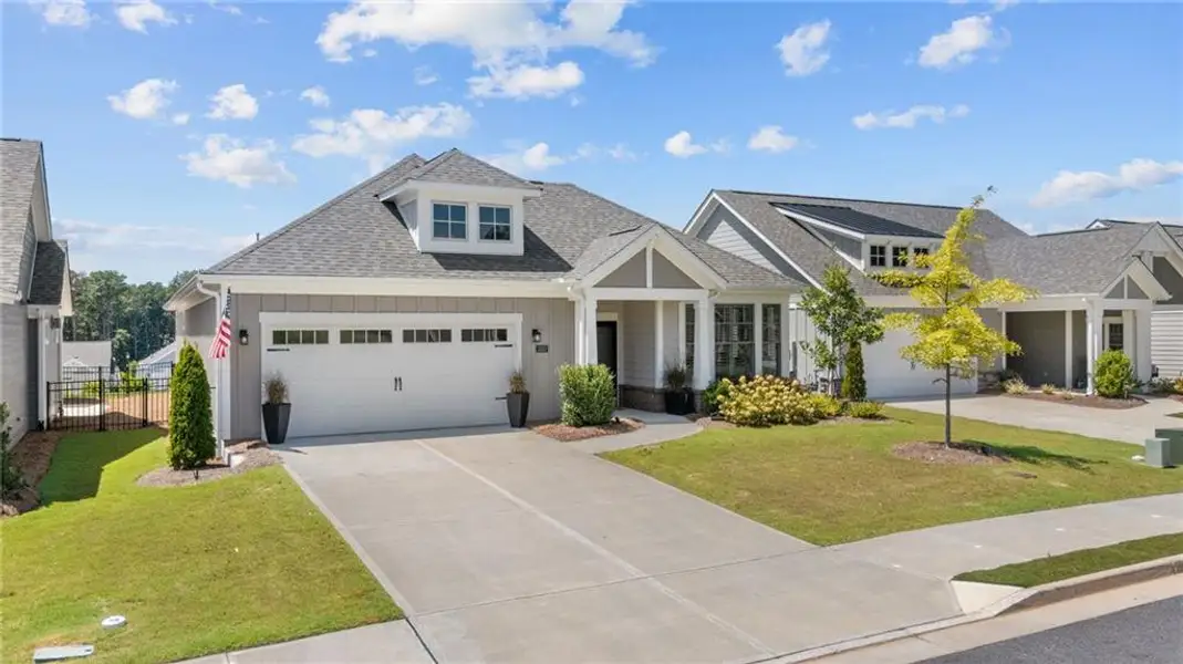 Front exterior of a new home in The Courtyards at Bailey Farms, Dacula, GA, highlighting curb appeal (Image 24).
