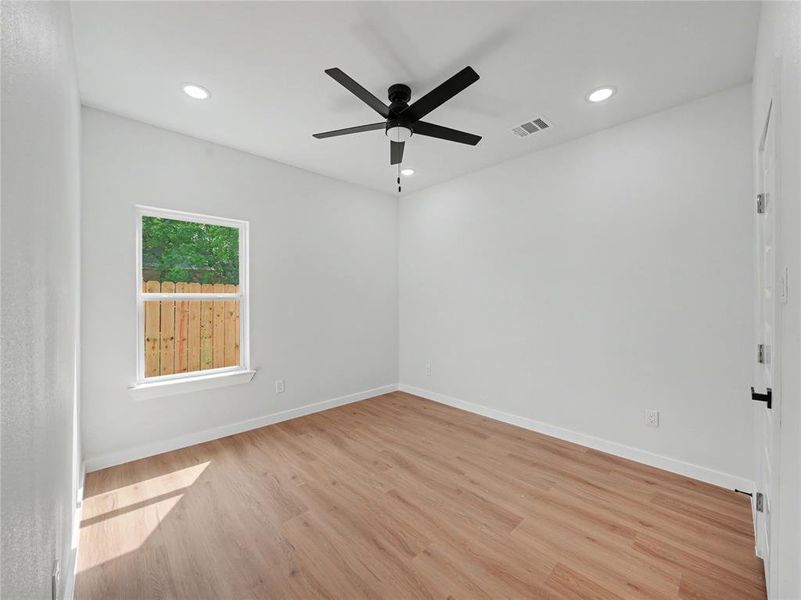 Unfurnished room featuring light wood-style flooring, ceiling fan, and recessed lighting