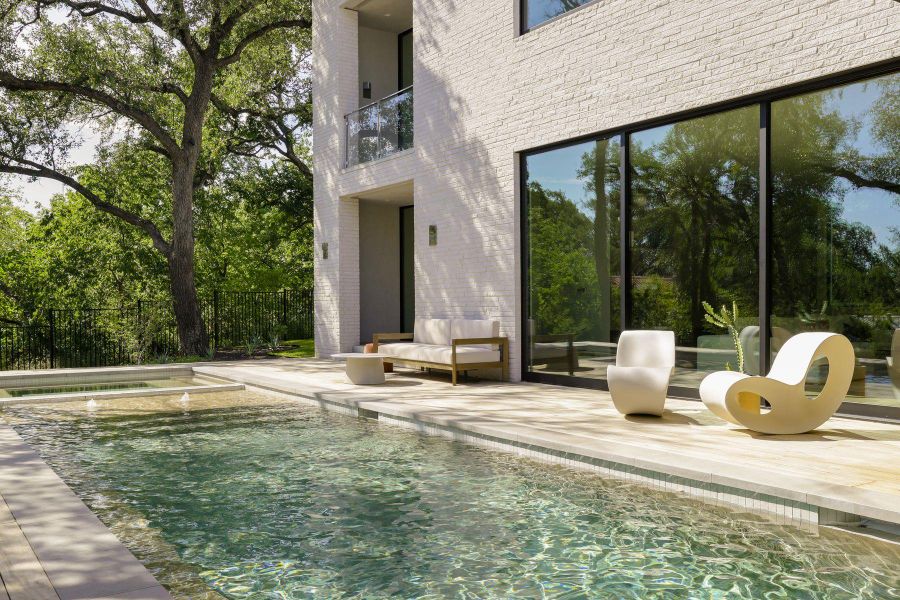 Combined pool / hot tub with a balcony and a patio