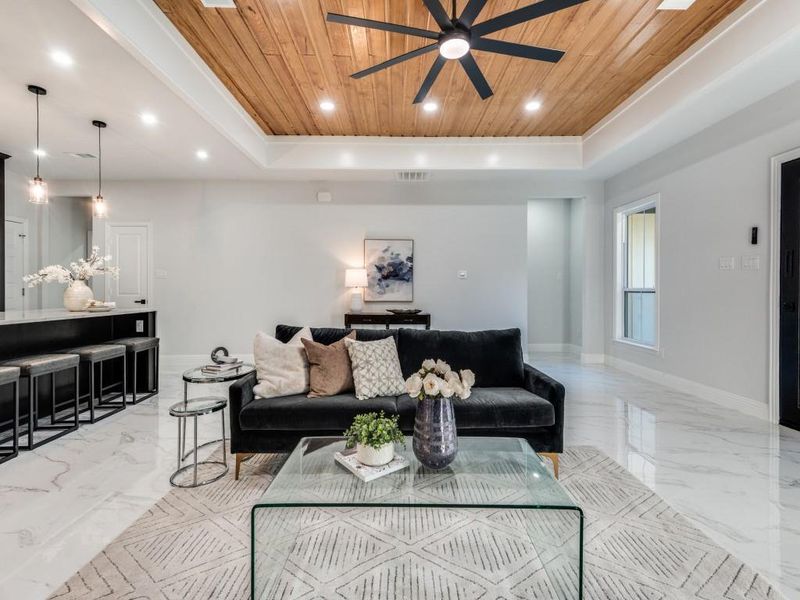 Living area featuring wood ceiling, light marble finish floors, recessed lighting, wood ceiling, and ceiling fan.