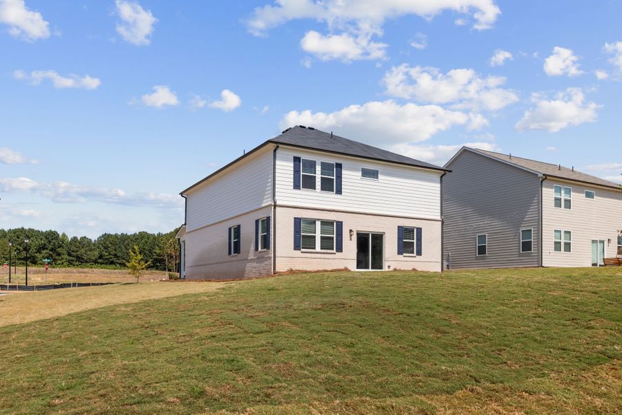 A large house with a lawn in front of it.