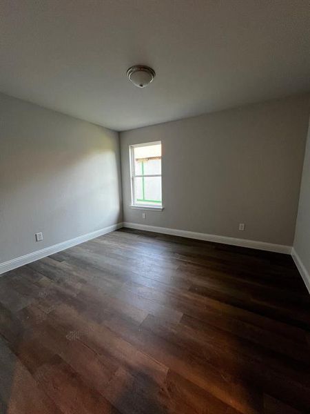 Unfurnished room featuring dark hardwood / wood-style flooring