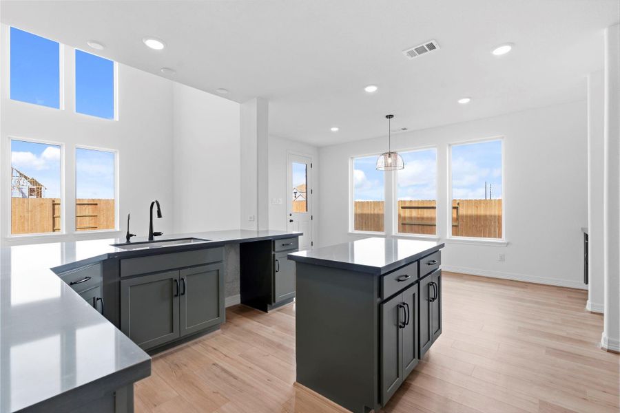 Bold, design-forward kitchen showcasing the AW Collection Rosemary , light countertops, and sleek modern backsplash.