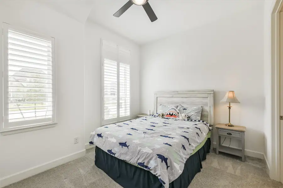 Front secondary bedroom has plantation shutters, fan, and ensuite bath. Front secondary bedroom has plantation shutters, fan, and ensuite bath.