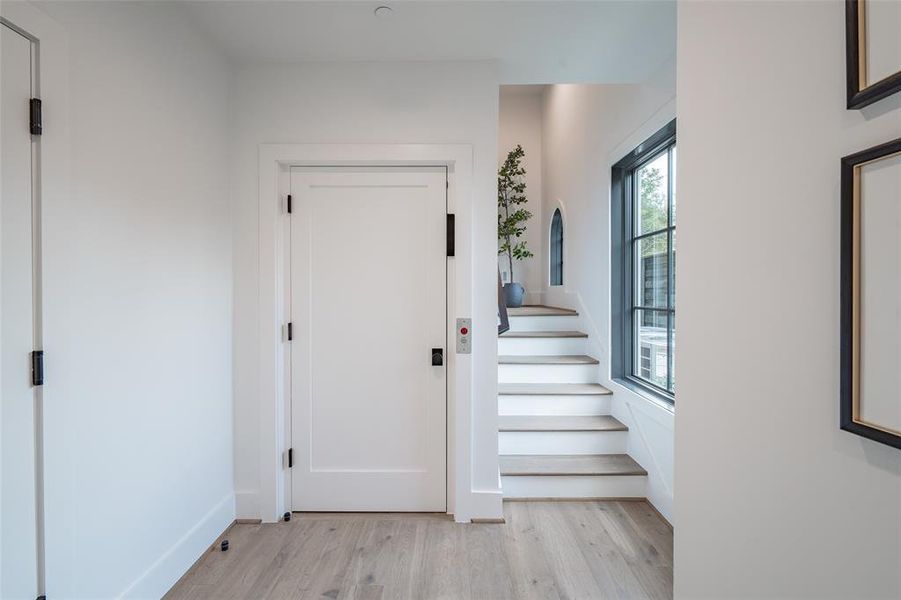 Foyer entrance with light hardwood / wood-style flooring